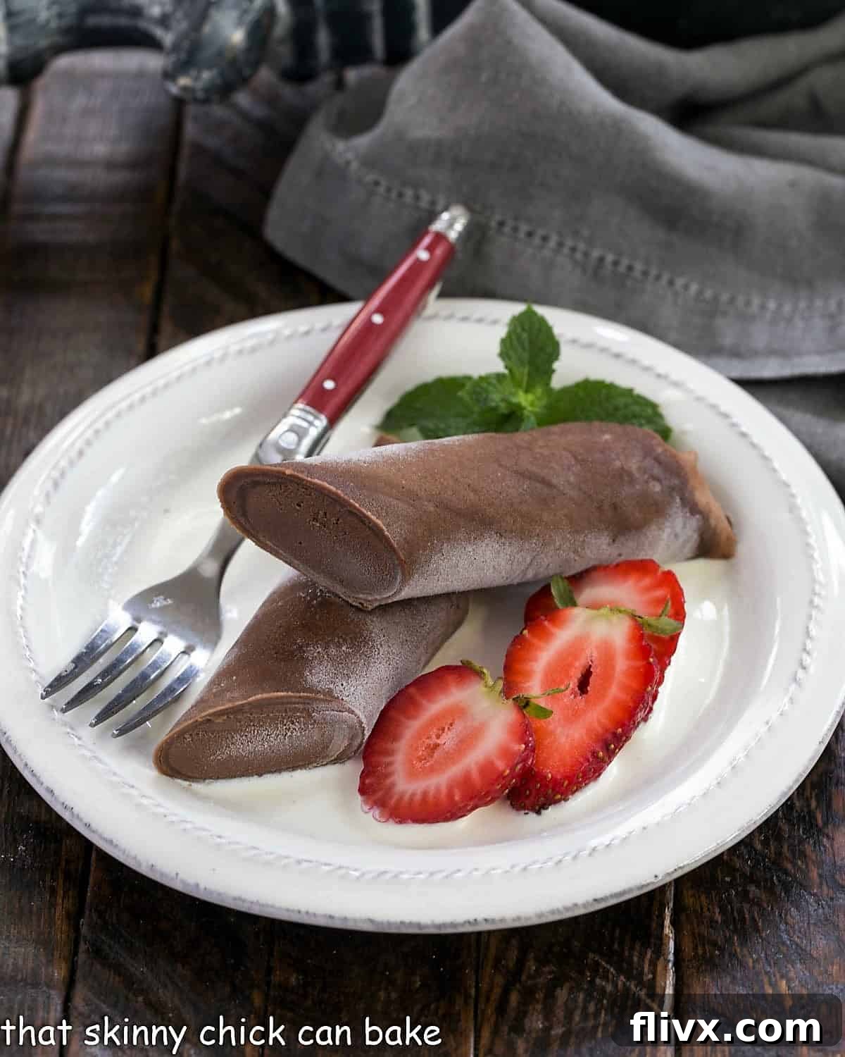 Frozen chocolate crepe sliced in half and served over creme Anglaise with sliced strawberries.