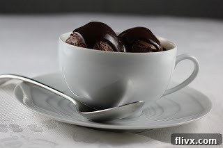 Chocolate Ice Cream with Fudge Sauce in a charming white teacup, a unique and delightful way to serve this decadent dessert.