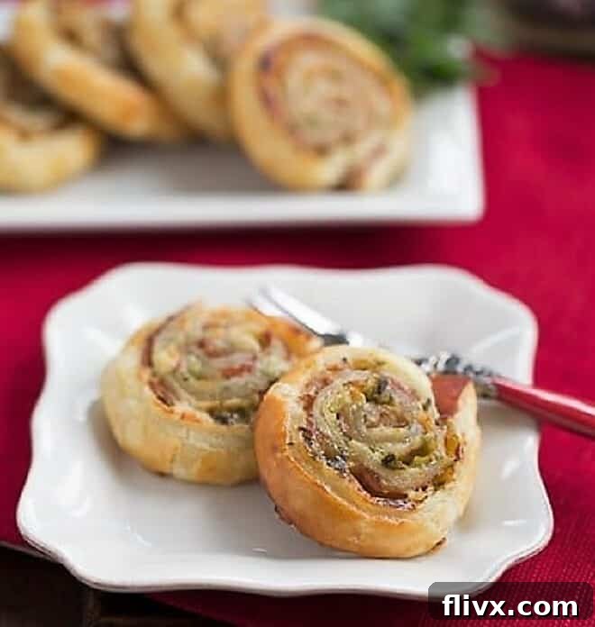 Prosciutto, Gruyere and Basil Pinwheels on a white plate with a fork