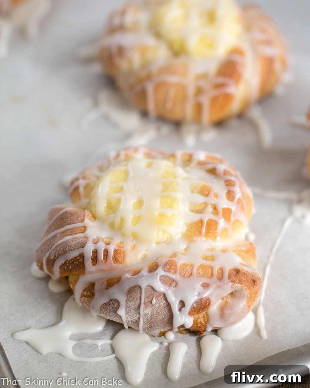 Danish Twists with Cream Cheese Filling on a parchment lined sheet pan.