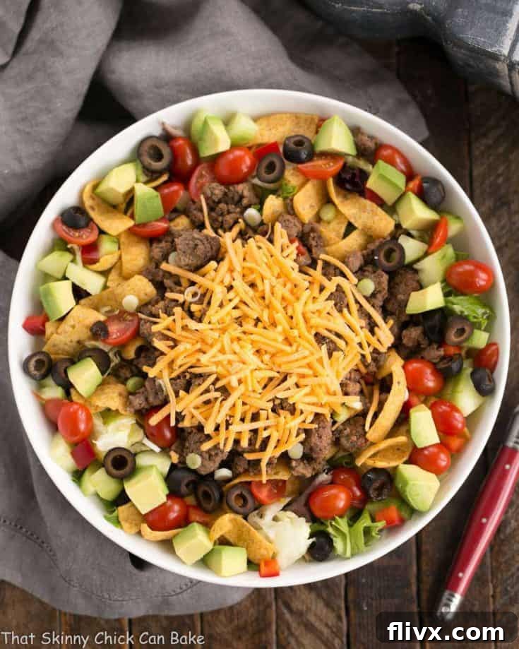Beef Taco Salad with Salsa Dressing - a Tex-Mex salad with spicy ground beef, veggies, cheese and a creamy salsa dressing