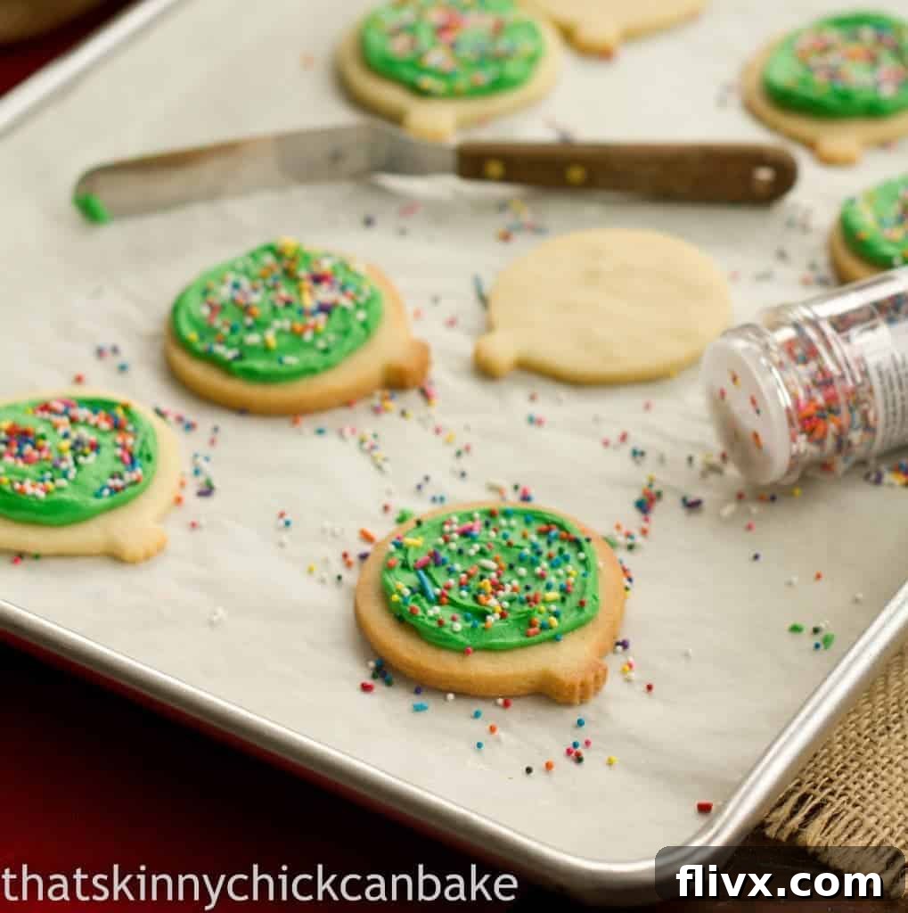 Perfectly frosted sugar cookies arranged on a baking sheet, ready to be enjoyed.