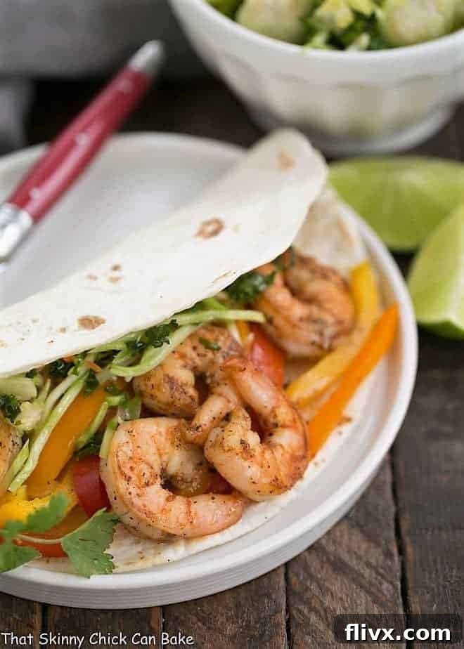 Spicy Shrimp Fajitas presented beautifully on a white ceramic plate, ready to be served.