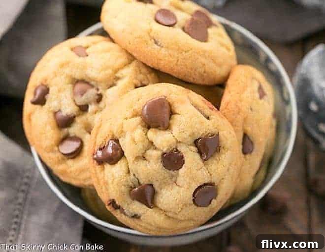 A stunning close-up of a stack of Double Chocolate Chip Cookies, showcasing their perfectly baked texture and generous scattering of chocolate chips, ready to be enjoyed.