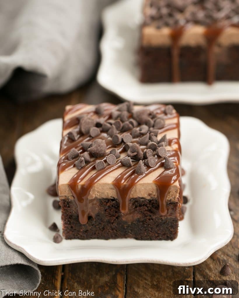 Two generous slices of Chocolate Kahlua Poke Cake, revealing the moist interior and the creamy topping, ready to be enjoyed.