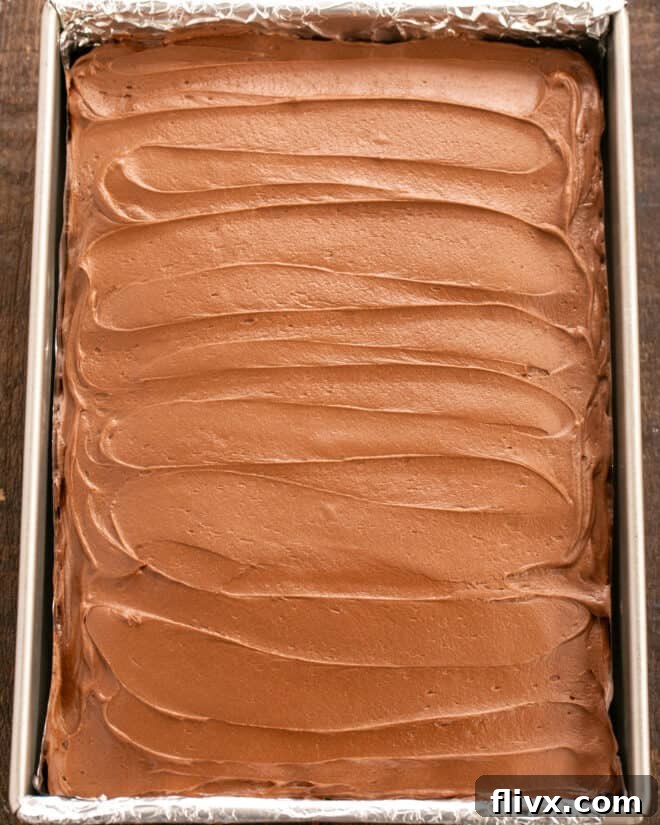 Spread frosting over cooled cake.