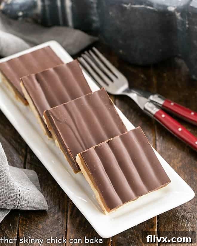 Close-up view of a tray filled with freshly made Homemade Twix Bars, perfectly showcasing the layers of shortbread, caramel, and chocolate.
