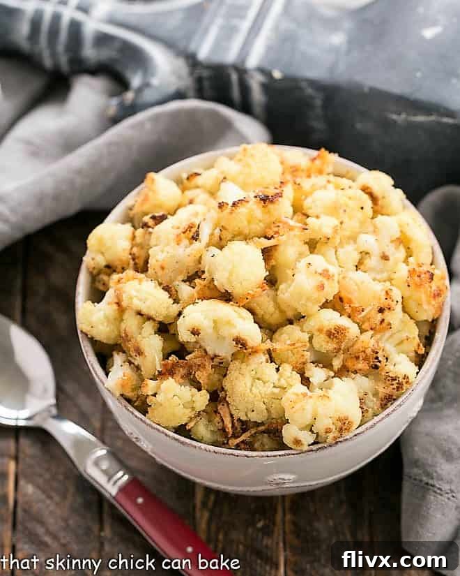 Overhead view of Roasted Cauliflower with Parmesan and Bread Crumbs in a round white bowl, beautifully golden and ready to serve.