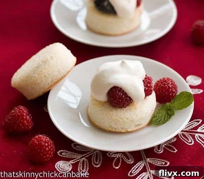 Emeril's Angel Cake Sandwiches, a beautifully presented dessert featuring fluffy angel food cake, fresh berries, and whipped cream, ready to be enjoyed.