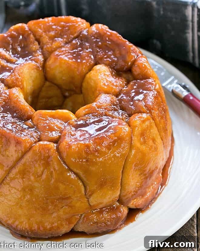 The original easy Monkey Bread, made with full-sized roll dough, elegantly presented on a pristine white serving plate, showcasing its classic form and delicious appeal.