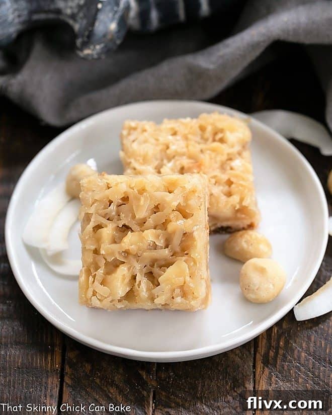 Perfectly baked Coconut Macadamia Nut Bars arranged on a beautiful round white ceramic plate, ready to be enjoyed.