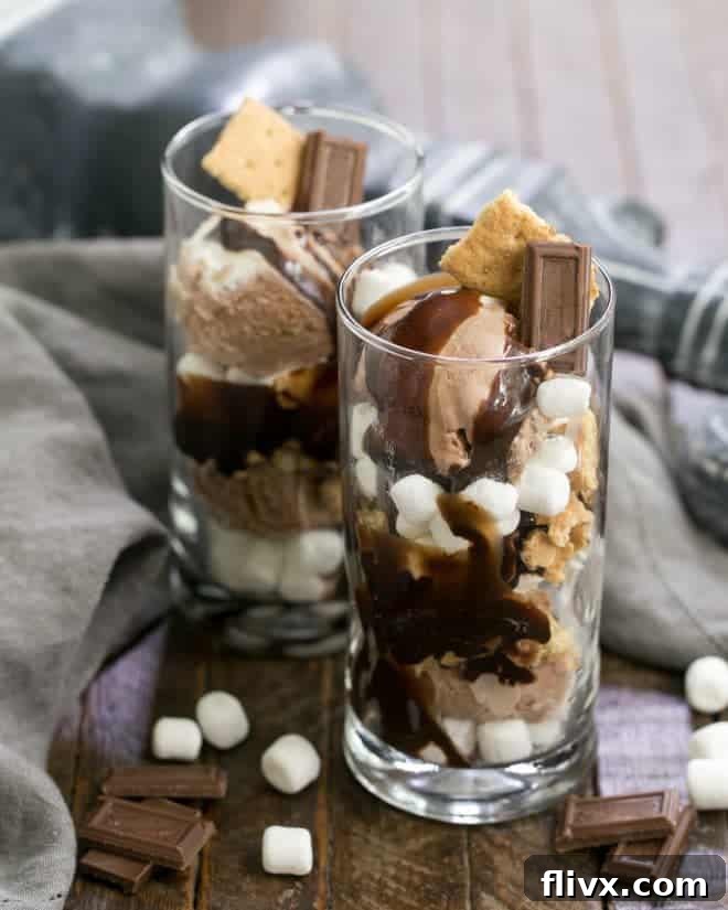 Close-up of a beautifully assembled S'mores Ice Cream Sundae, showcasing the layers of ice cream, marshmallows, graham crackers, and fudge, ready to be enjoyed as a frozen summer treat.