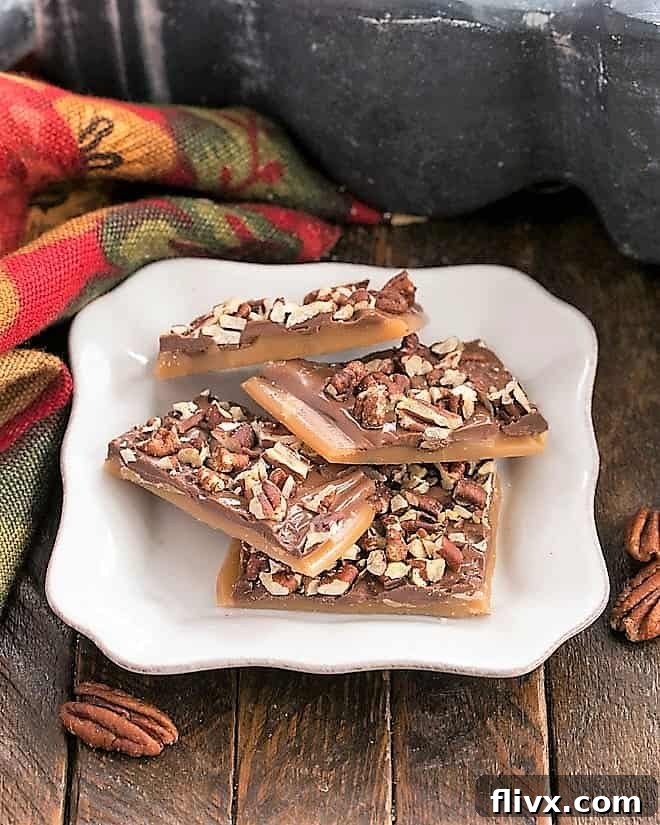 English toffee on a square white plate, with chocolate and nuts.