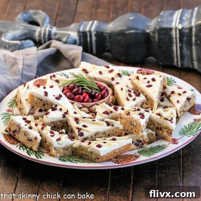 A beautifully arranged festive oval tray showcasing copycat cranberry bliss bars, ready for serving.