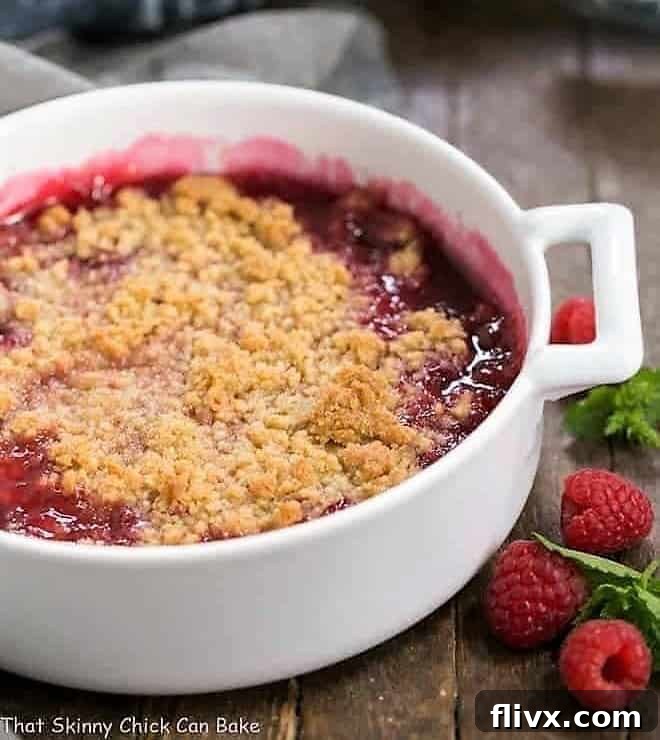 Fresh Raspberry Crisp in a round white casserole dish.