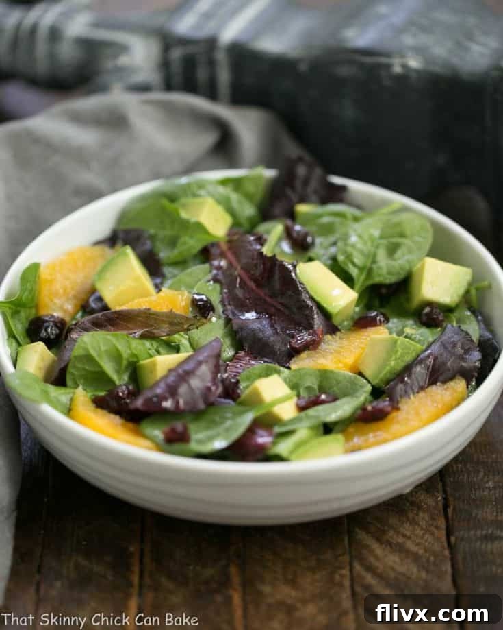 A vibrant Citrus Spinach Salad with Avocados and Oranges, complete with a lovely lemon Dijon vinaigrette, presented beautifully for a healthy meal.