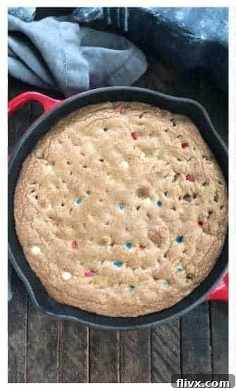 A golden brown skillet cookie baking in the oven.