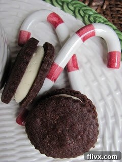 Chocolate cookie dough being rolled out between parchment paper