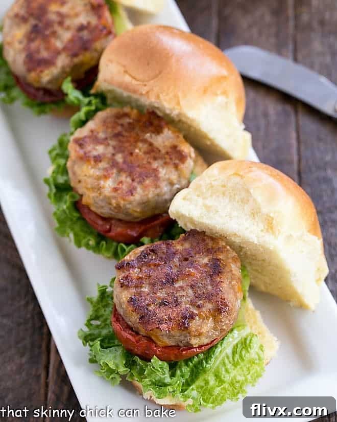 Turkey Sliders with Roasted Tomatoes lined up on a white serving tray, ready to be enjoyed.