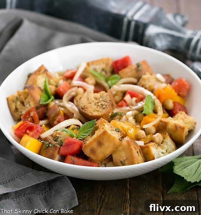 Summer Tomato and Burrata Panzanella Salad in a white ceramic serving bowl