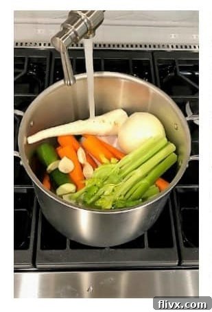 Cover chicken and vegetables with water, an inch over the ingredients.