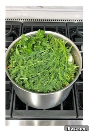 Add fresh dill and simmer the chicken soup for 3 hours. Then, prepare chicken and veggies.