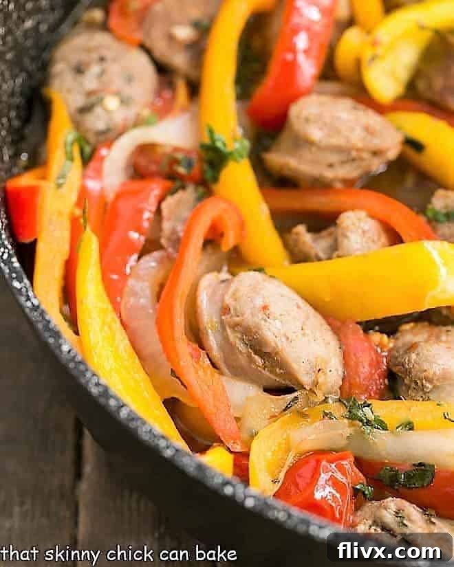 Skillet Italian Sausage and Peppers - a comforting, flavorful meal that's easy to prepare and can be served with Provolone for an unforgettable sandwich! Close-up view of vibrant Italian Sausage and Peppers sizzling in a skillet, showcasing rich colors and textures