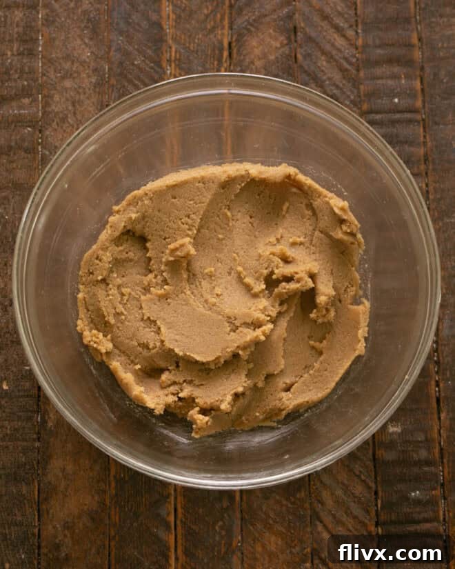 Step 3: Creaming butter and sugars together until the mixture becomes light, fluffy, and well-blended.