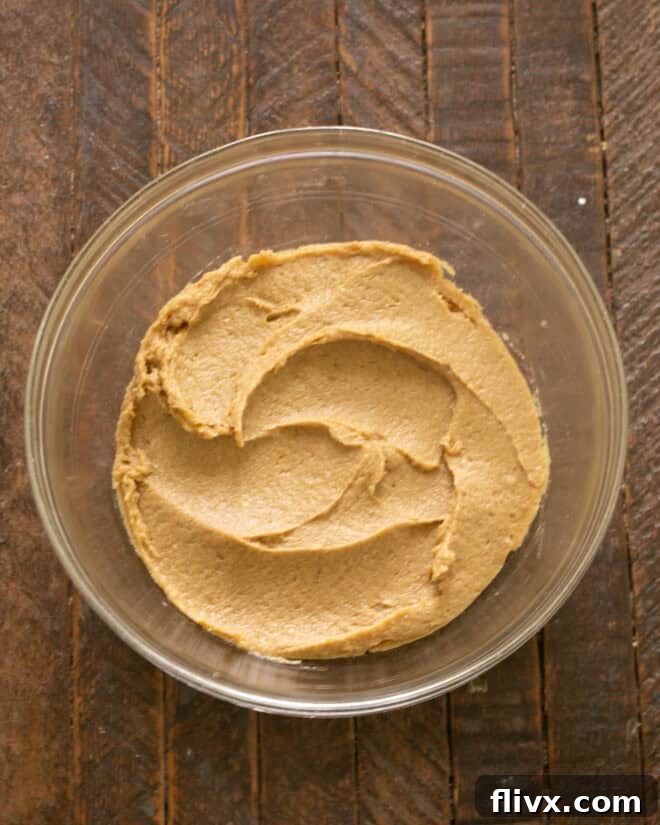 Step 5: Continuing to mix the wet ingredients until the batter achieves a light and creamy consistency.