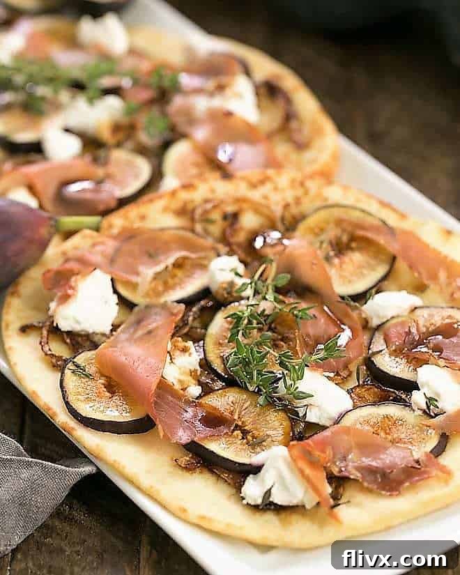 Delicious Fig, Goat Cheese and Prosciutto Pizza on a white serving tray, ready to be enjoyed.