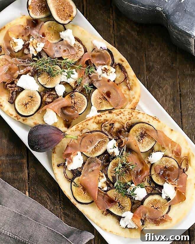 A stunning Fig, Goat Cheese and Prosciutto Pizza served on a white platter, garnished with fresh figs and thyme.