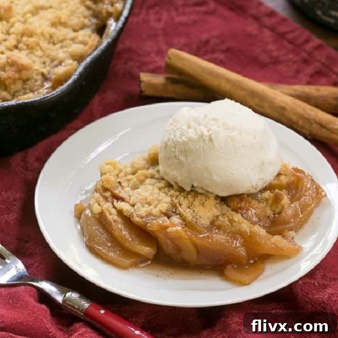 Grilled Apple Crisp topped with vanilla ice cream, showing smoky undertones.
