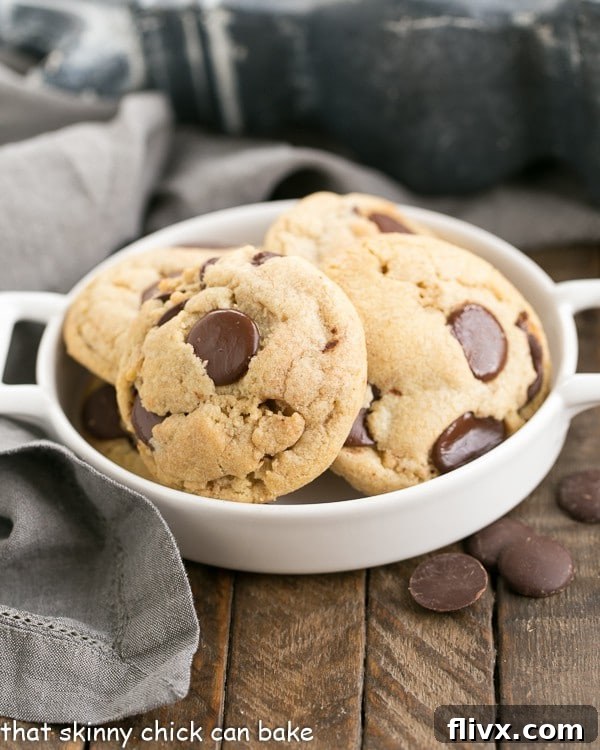 Thick and Chewy Chocolate Chip Cookies in a shallow handled dish. A massive amount of chocolate in each and every fabulous cookie!!!