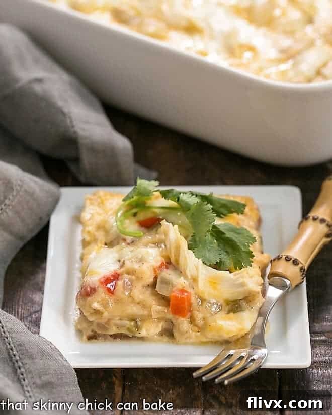 Homemade King Ranch Casserole on a white plate, garnished with fresh cilantro.