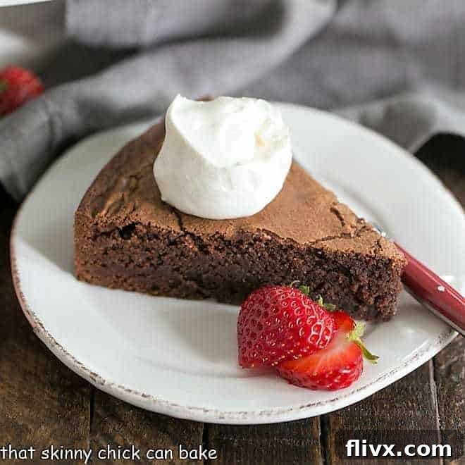 Italian Flourless Chocolate Cake with a dollop of cream, berries and a fork