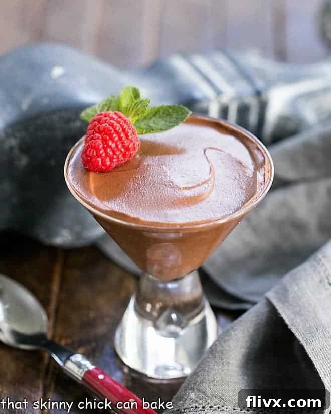 Chocolate Truffle Mousse AKA Mousse au Chocolat in a martini glass with a raspberry and mint
