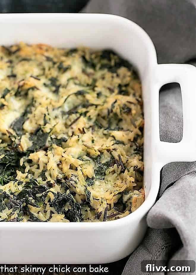 Cheesy Spinach Rice Casserole baked in a white baking dish, ready to be served.