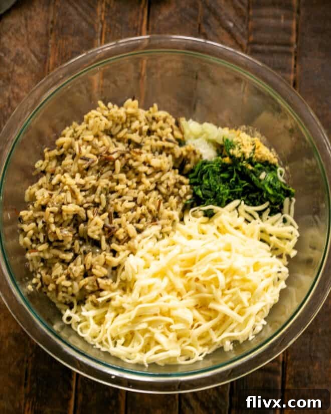 Shredded cheese and cooked rice being added to a mixing bowl.