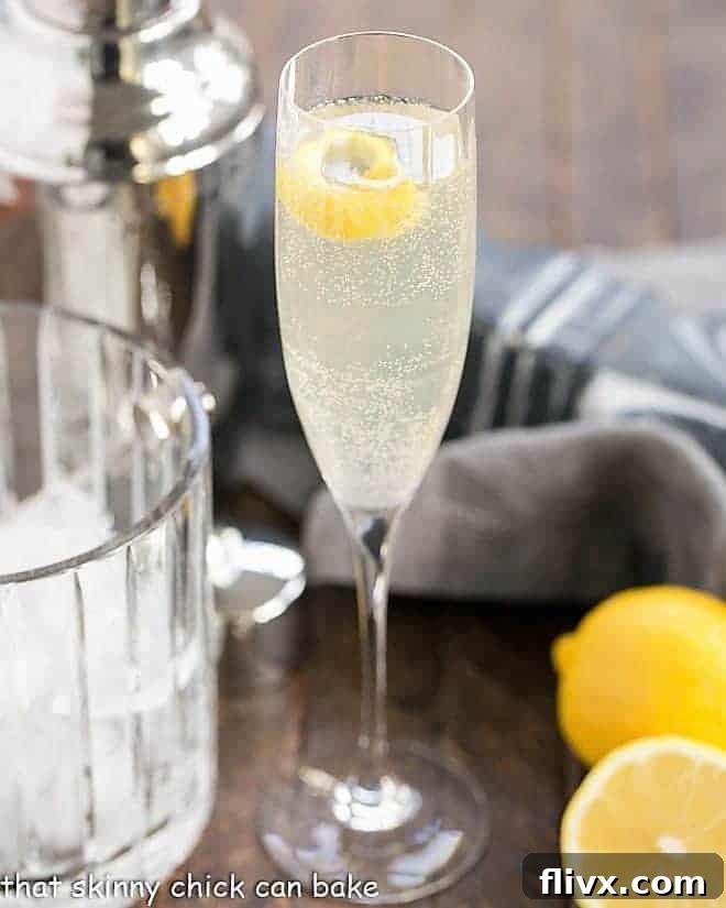 A French 75 Champagne Cocktail presented in a elegant champagne flute, garnished with a lemon twist.