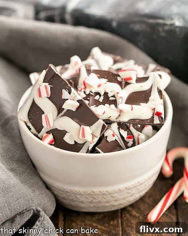 Swirled Peppermint Bark in a white bowl, showcasing the beautiful dark and white chocolate swirl with crushed candy canes.
