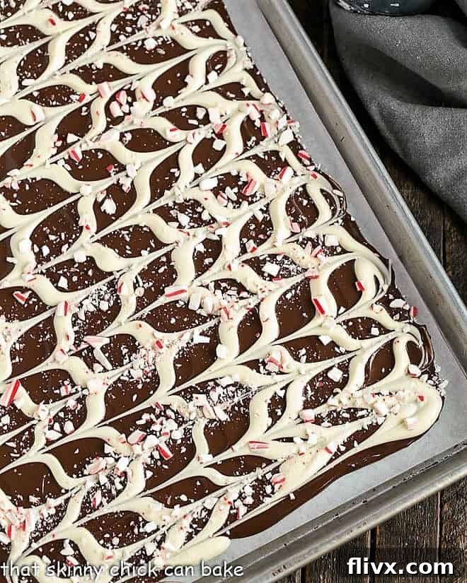 Swirled Peppermint Bark on a sheetpan, freshly made and ready to be broken.