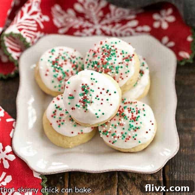 Italian Ricotta Cookies on a square white plate with a fork beside it, tempting to eat.