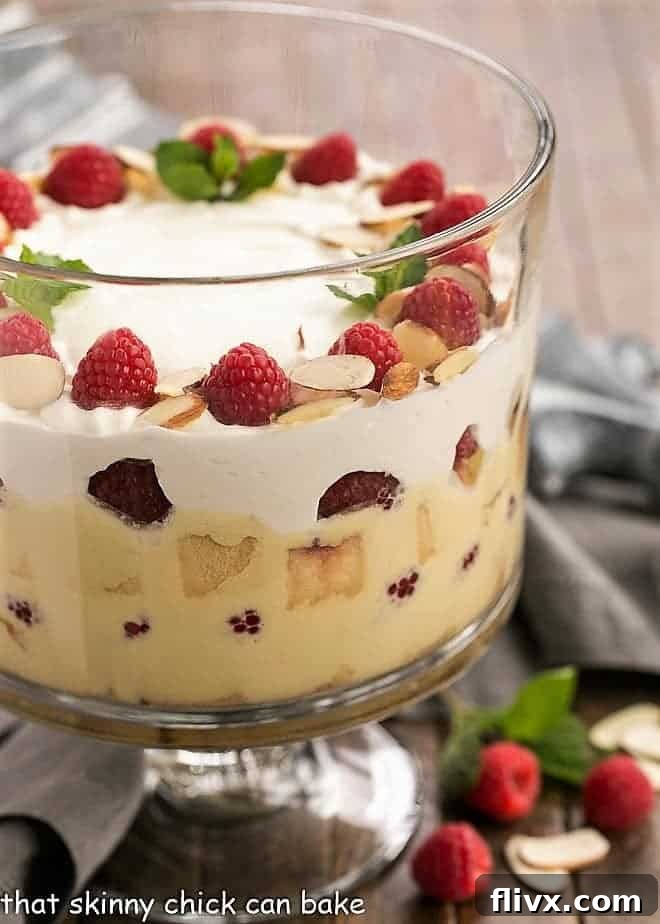 Traditional English Trifle side view in a glass trifle bowl, showcasing delicate layers of cake, custard, and fruit.