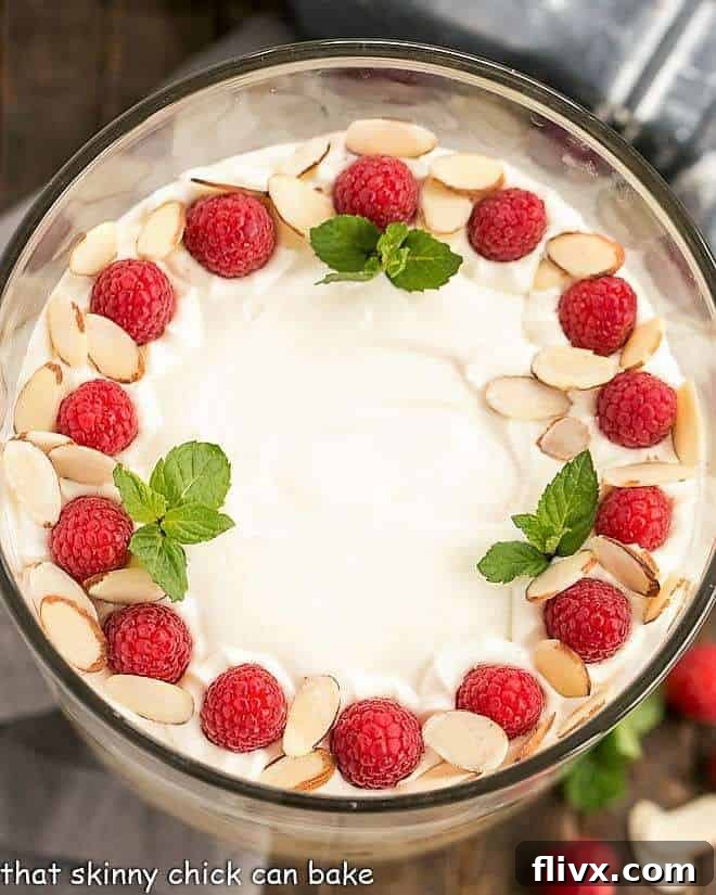 Overhead view of English trifle in a glass trifle bowl, showing the beautiful arrangement of fruit and cream.