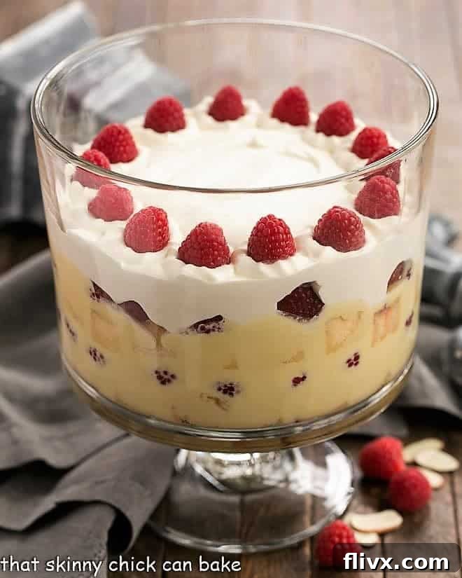 Traditional English Trifle topped with whipped cream and fresh raspberries