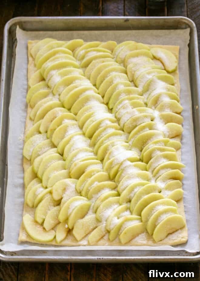 Step 4: Sprinkle apples generously with sugar, then dot with cold butter cubes.