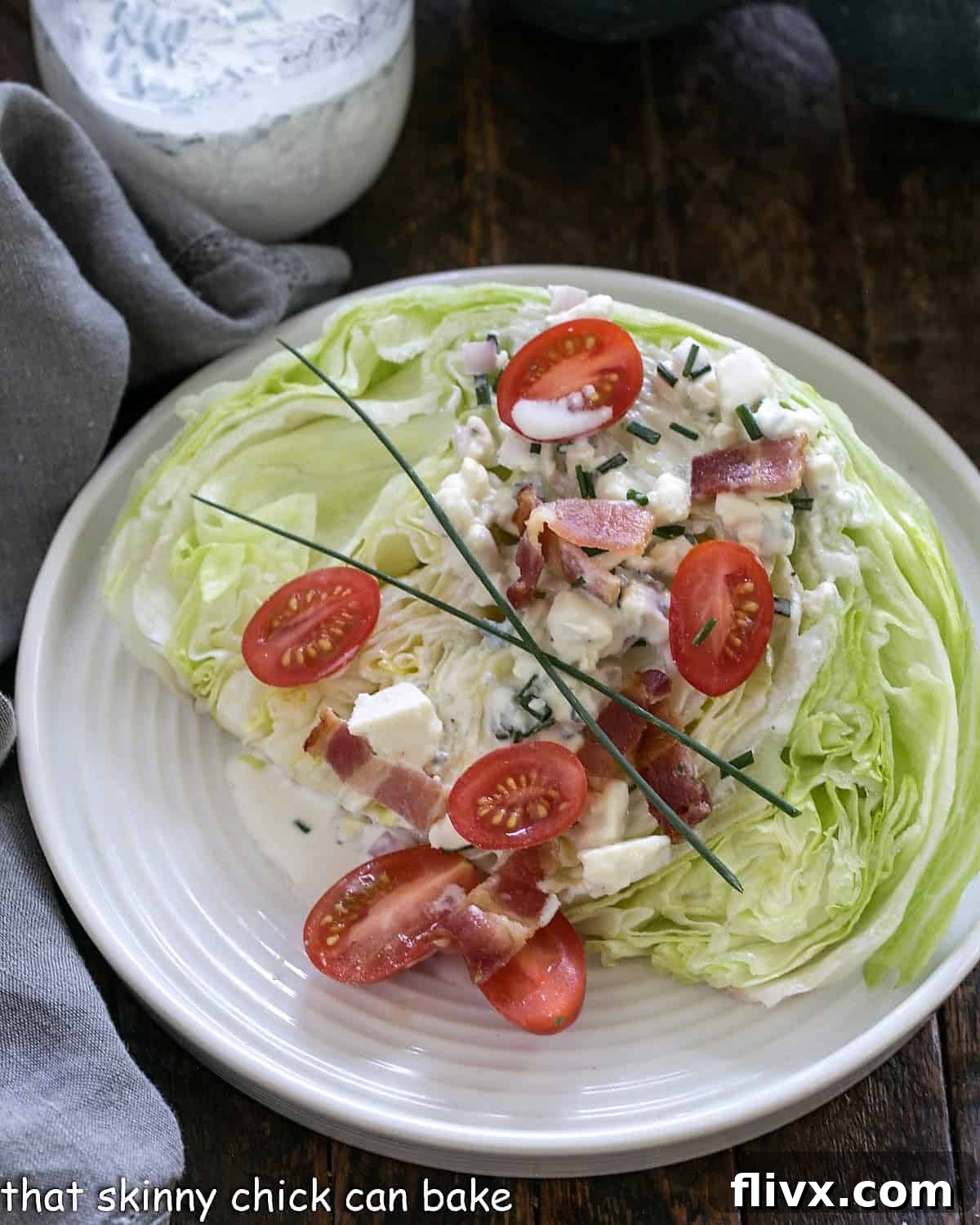 Overhead view of wedge salad on a white plate.