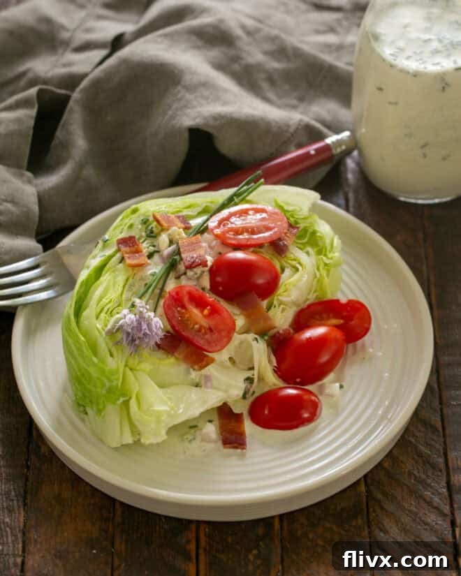 Step 2: Place lettuce wedges on plates and top with tomatoes, bacon, and chives and drizzle with blue cheese dressing.