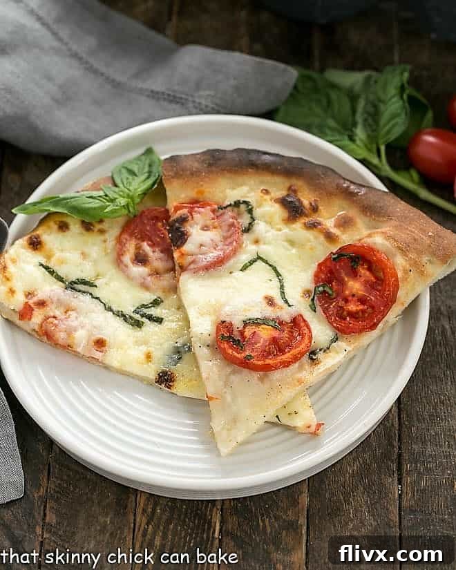 Two slices of pizza made with homemade pizza dough, showcasing a perfectly baked crust.