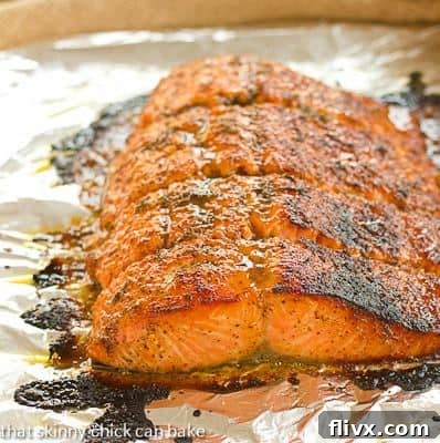 Maple Mustard Glazed Salmon - A super easy glaze, then 15 minutes in the oven for a terrific entree! A close-up view of roasted Maple Mustard Glazed Salmon on a foil-lined baking sheet, showing its perfect texture and glaze.
